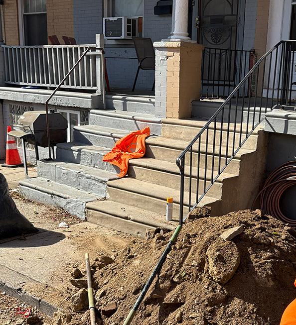 Water-line digging outside of a residence in the city.